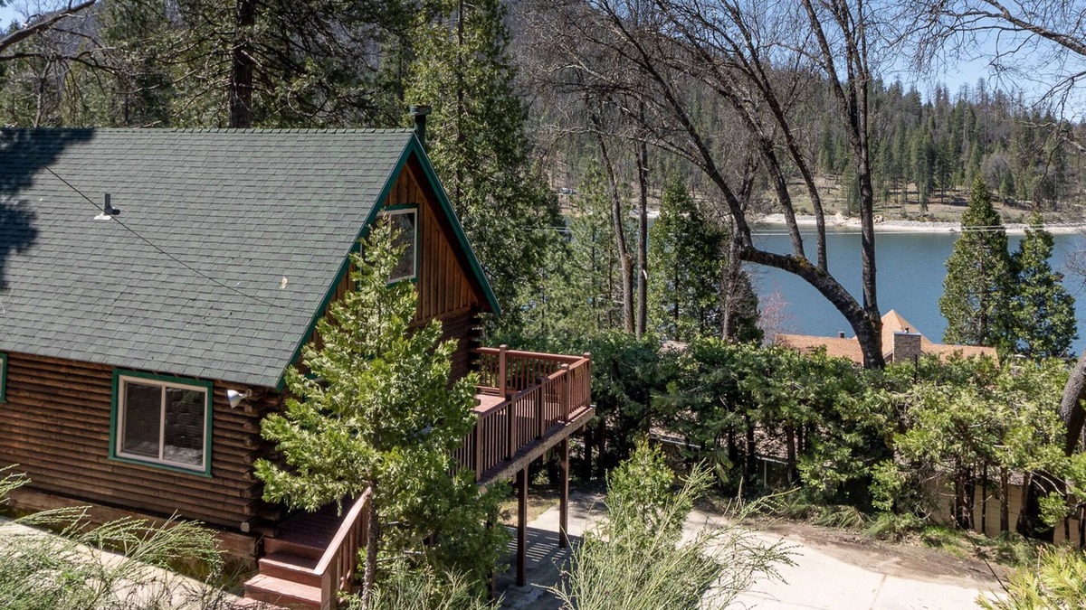 Bass Lake Cabin | 2 BR log cabin with lake view, wrap-around deck, Ping-Pong & wood stove