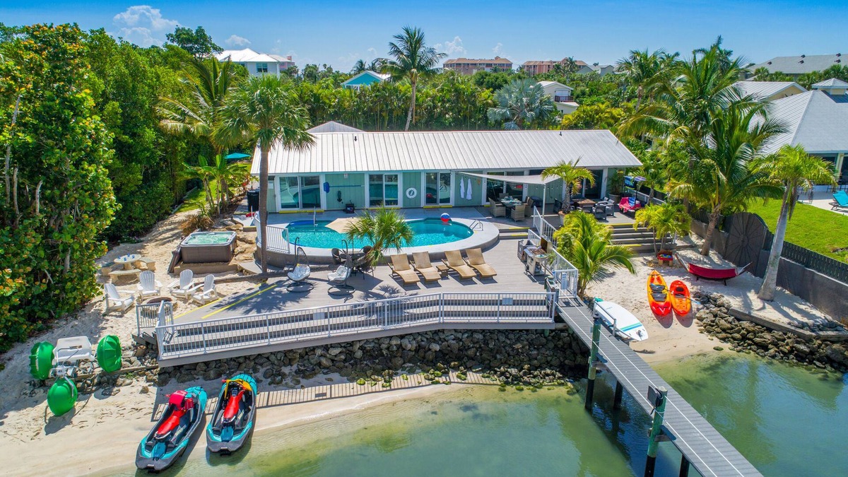 Stuart House | Aquatopia North: Riverfront beach house, w/dock, heated pool + hot tub & more!