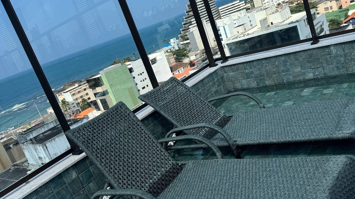 Ondina Apartment | Bedroom and living room in Ondina, Salvador, Bahia, decorated