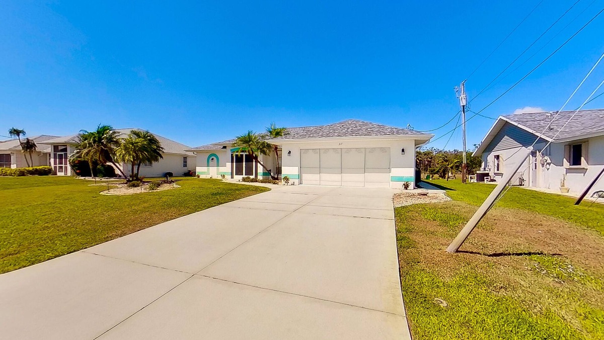 Pebble Beach House | Bohemian canal-front retreat with pool, beach gear, adult bikes, & AC - dogs ok