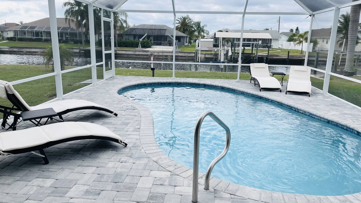 Gulf Cove House | Bright Waterfront Home. Heated Pool. Short drive to Beach. Beautiful Sunsets.