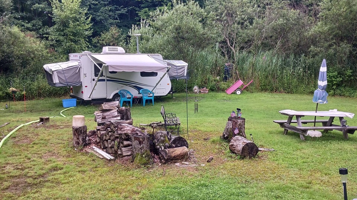 Forestville RV Rental | Comfortable Camper a few miles off thruway and area attractions. Fire ring wood