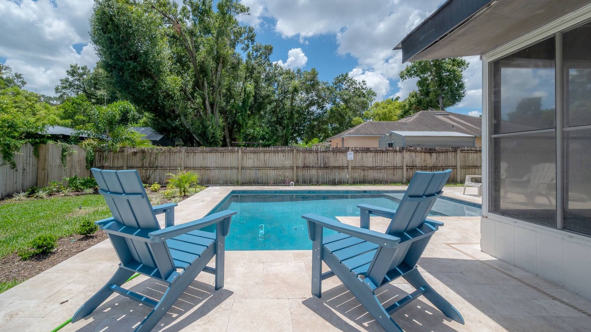 Bearss Plaza House | Contemporary Oaks Heated Pool + Screened Lanai