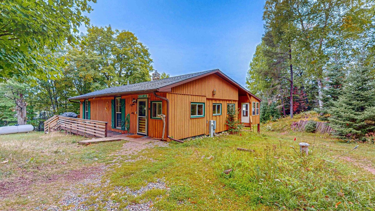 Presque Isle House | Dog-friendly lakefront home with boat access, deck, fireplace, gas grill, kayaks