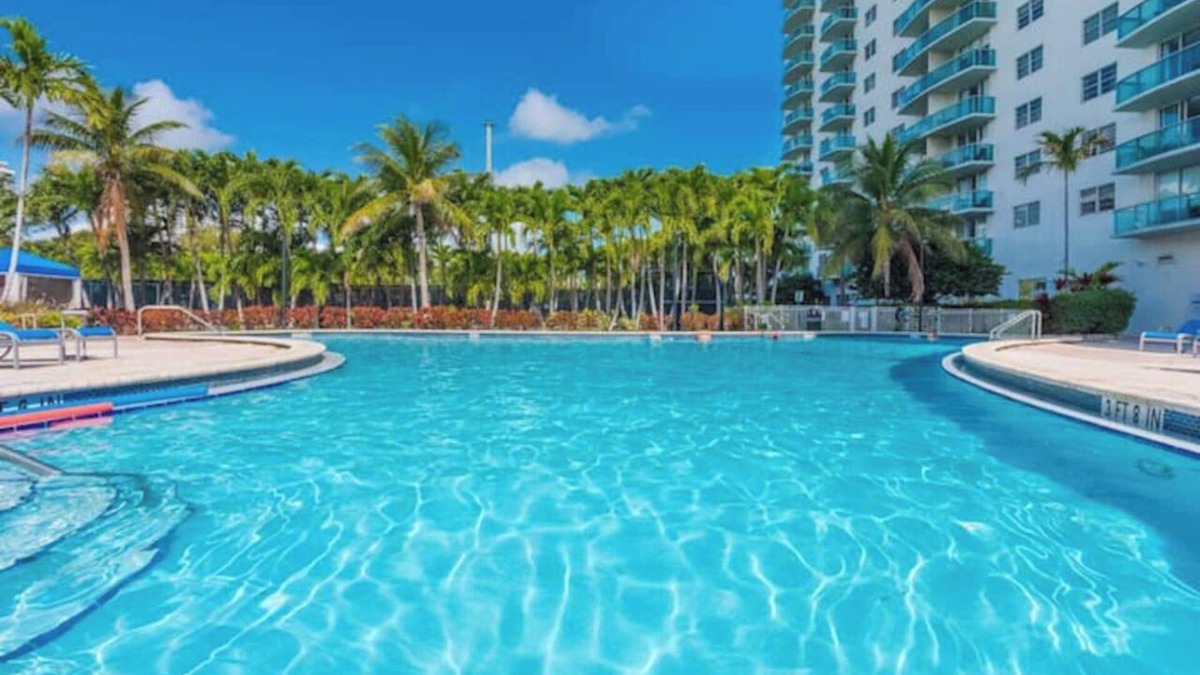 Aventura Condo | Entire condominium with a pool view, steps from the beach