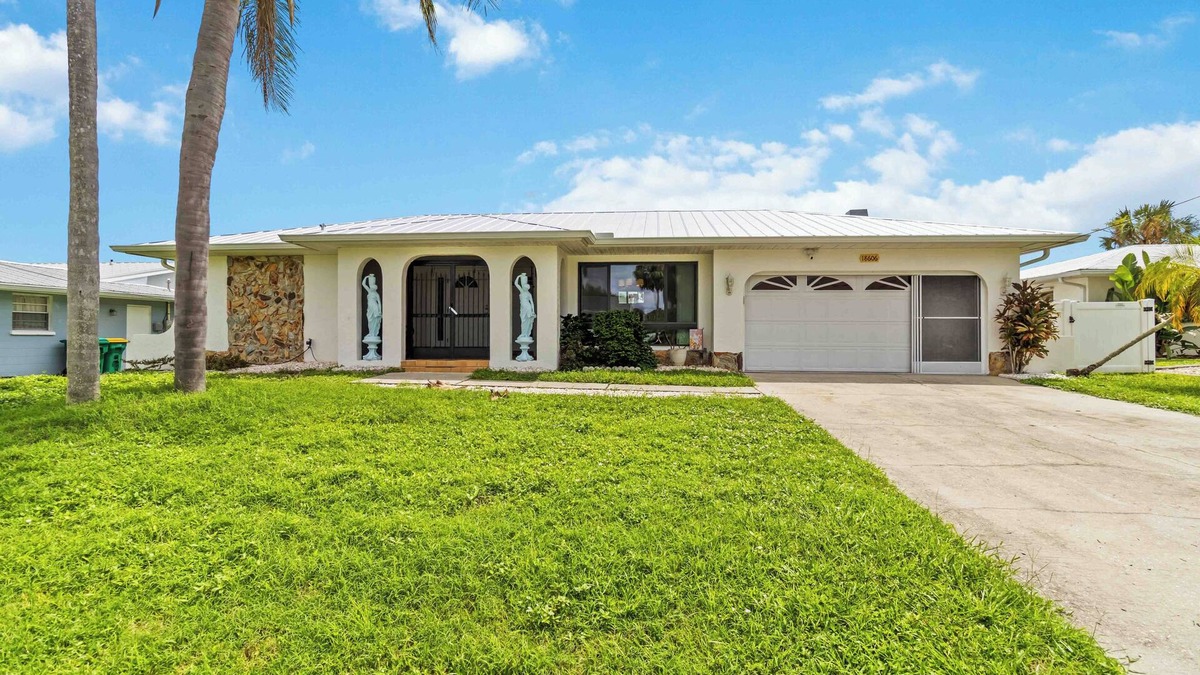 Port Charlotte House | Experience serenity in this fully furnished 3-bed, 3-bath waterfront home featuring a heated pool, spacious layout, and abundant natural light. Enjoy stunning water views from the master suite, living room and Florida room.