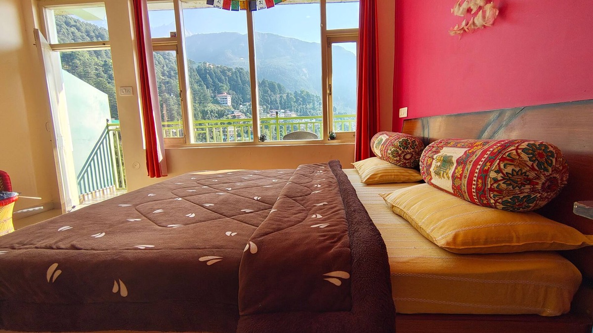 Dharamshala Bed & Breakfast | Golden View BnB Mcleodganj nRoom with private balcony facing mountain view.