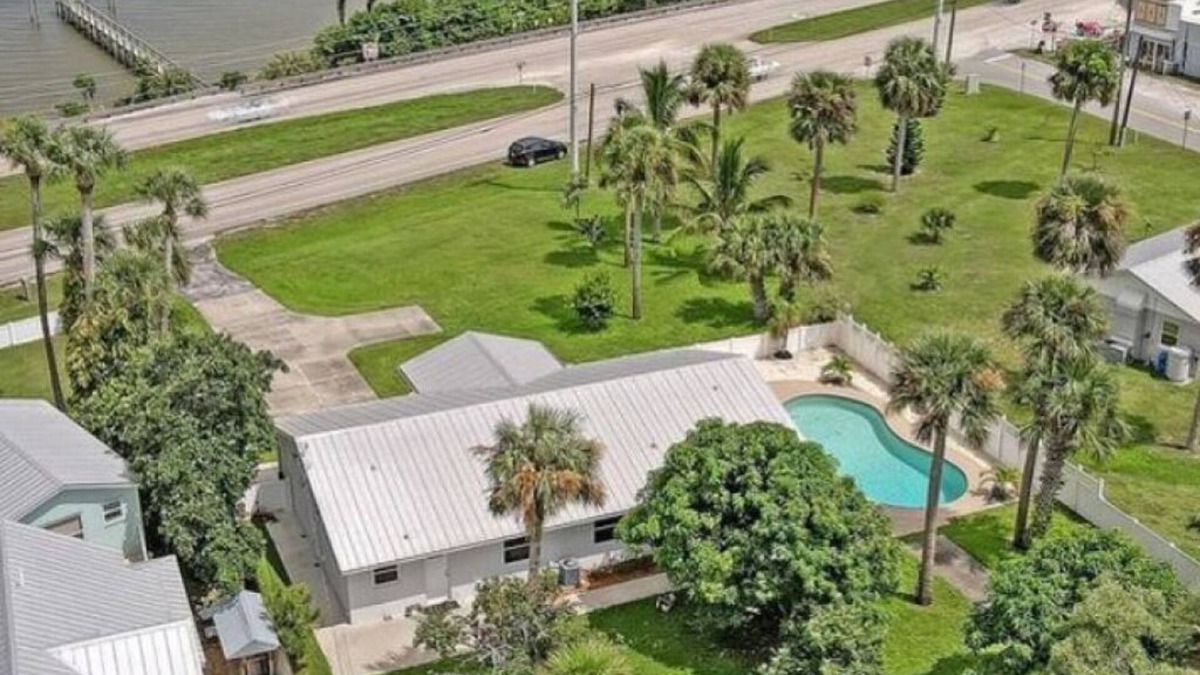 Micco House | Indian River Waterfront Home with private dock, heated pool, fenced back yard