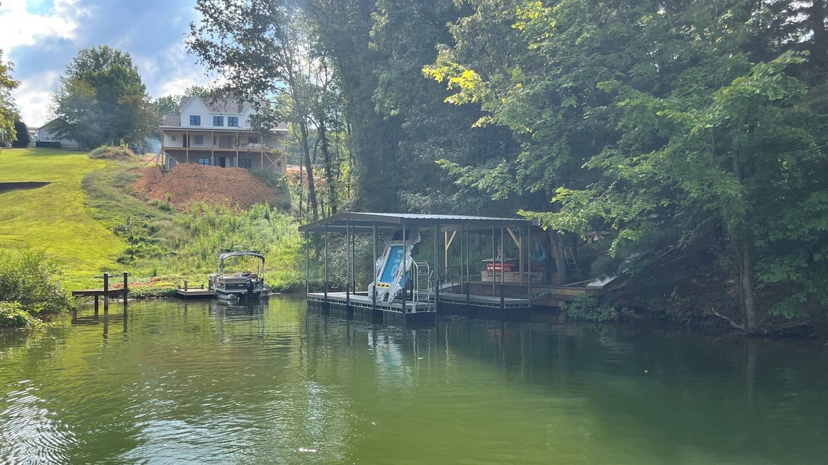 Winchester House | Lakefront home with dock. Cozy 2 bed 2 bath and screened in porch.