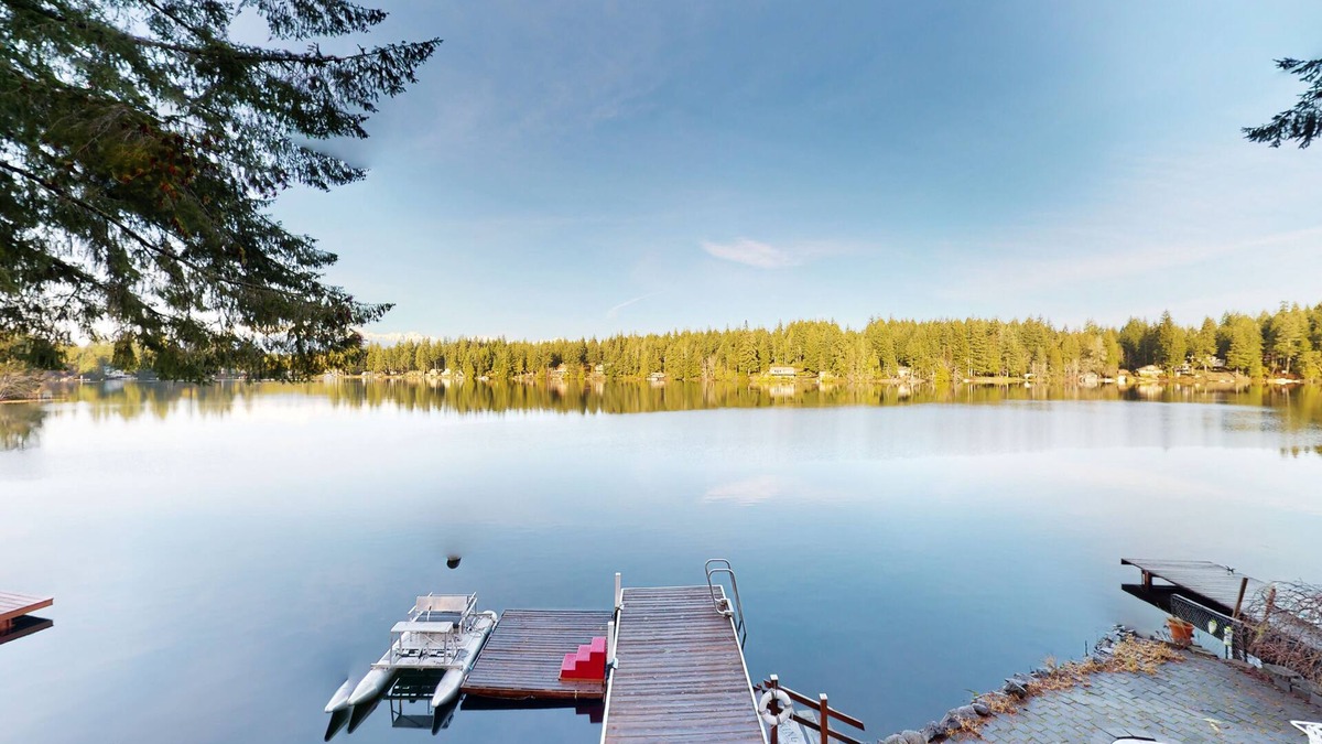 Mason County House | Lakefront studio-like home with beach access, lake views, wood stove, & firepit