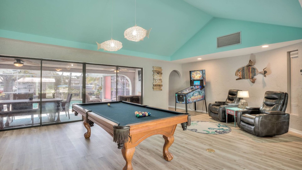 Yacht Club House | Lovely Canal Home in SW Cape with heated pool, game room, and a tiki on the dock