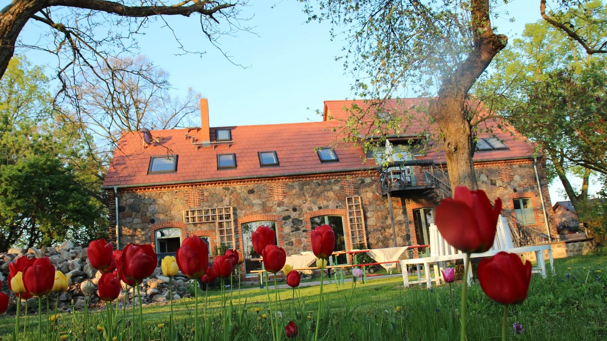 Klosterdorf House | Lovingly restored fieldstone barn with fireplace and woodchip heating.