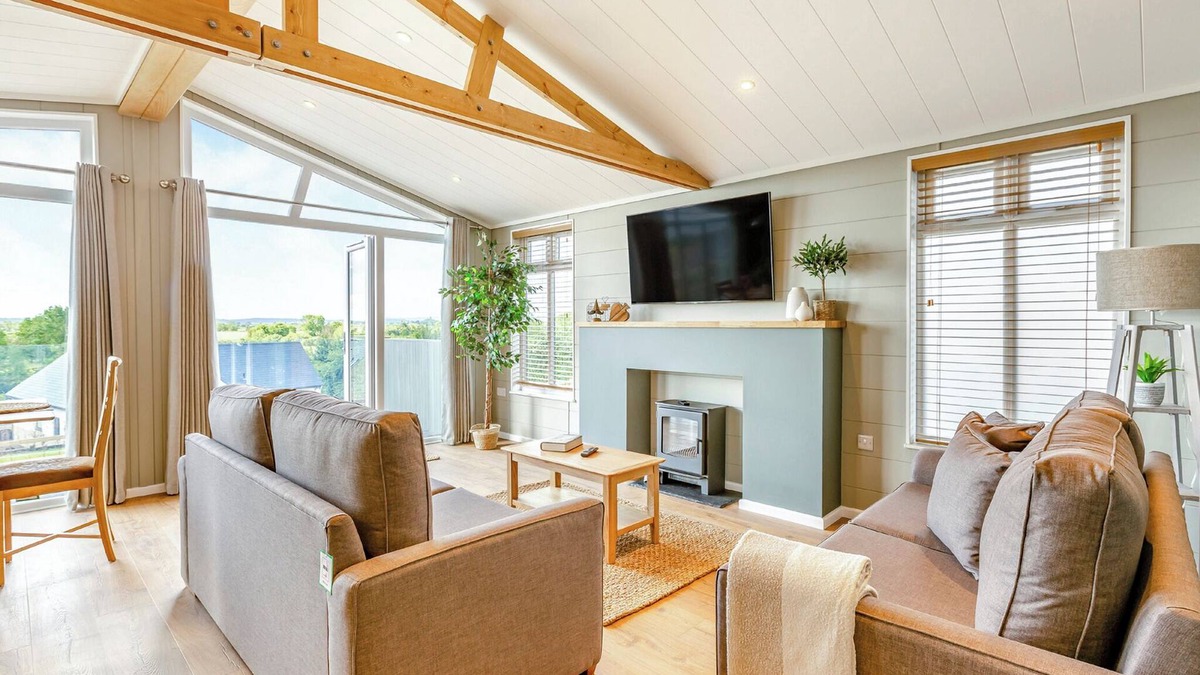 Middlezoy Ski Chalet | Luxurious lodge with vaulted ceilings and a welcoming feature fireplace.