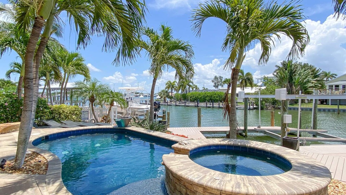 Clewiston House | Luxury Construction, Heated Pool on Canal, 3 Minute Walk to sugar sand of FMB!