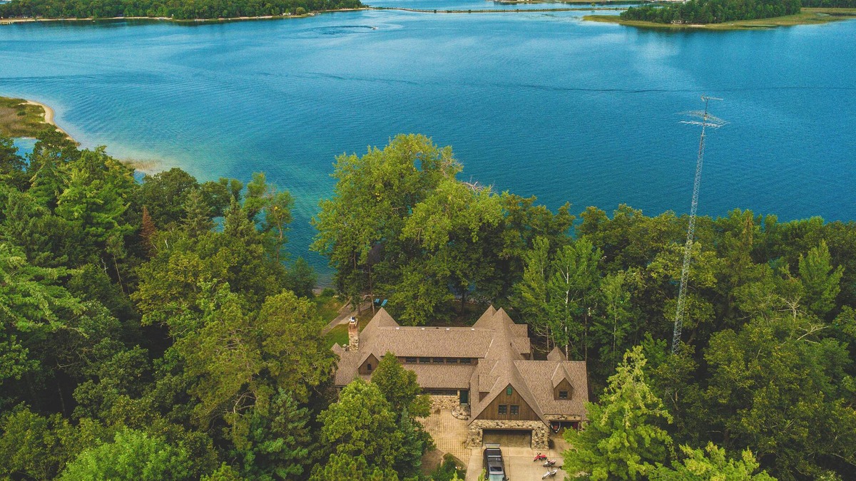 Nevis House | Luxury Lake Belle Taine retreat with private beach, sauna & four-season fun.