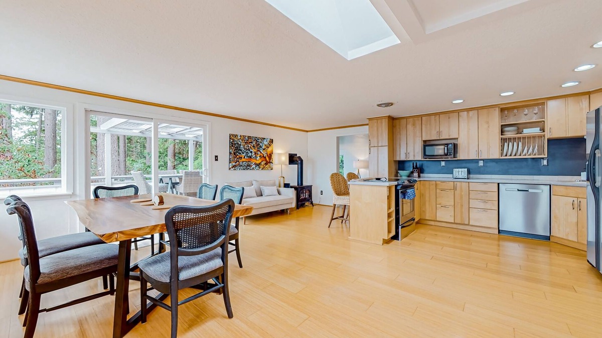 Adelma Beach House | Modern water view retreat with foosball table, expansive deck, and gas fireplace
