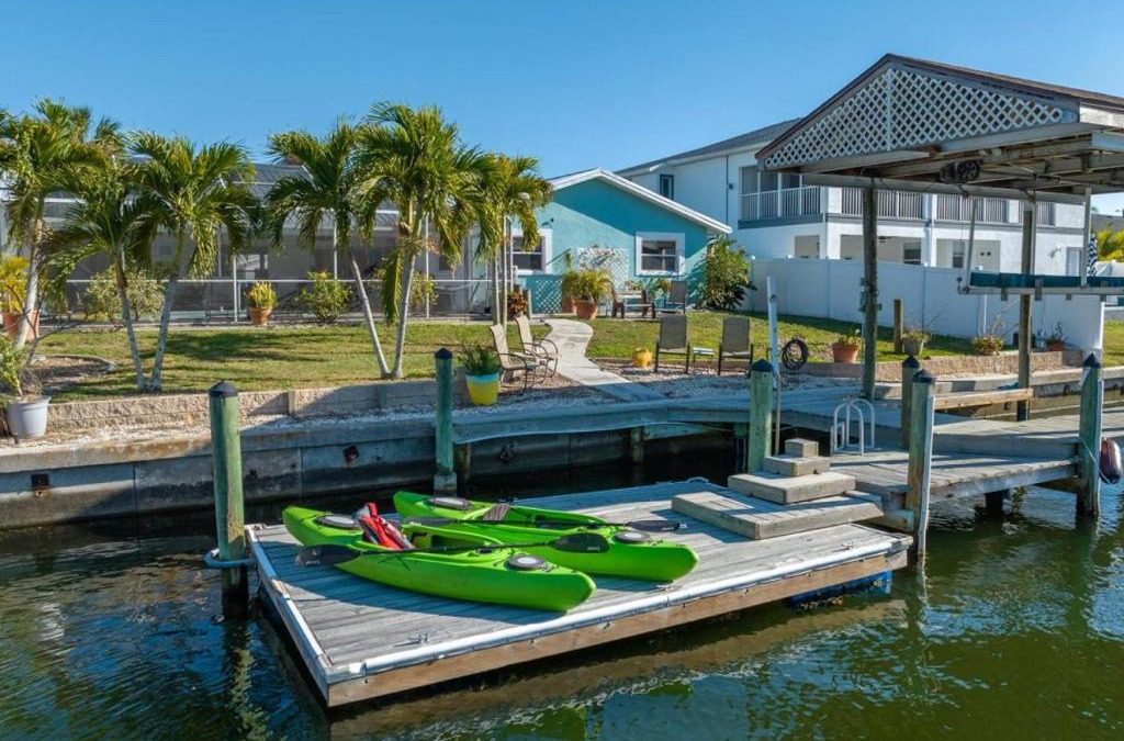 Bal Harbour House | Pirates Den a 4BR Pet-Friendly Waterfront Oasis with Pool, Dock, Personal Water Boats, Fire Pit, Game Room and Bar
