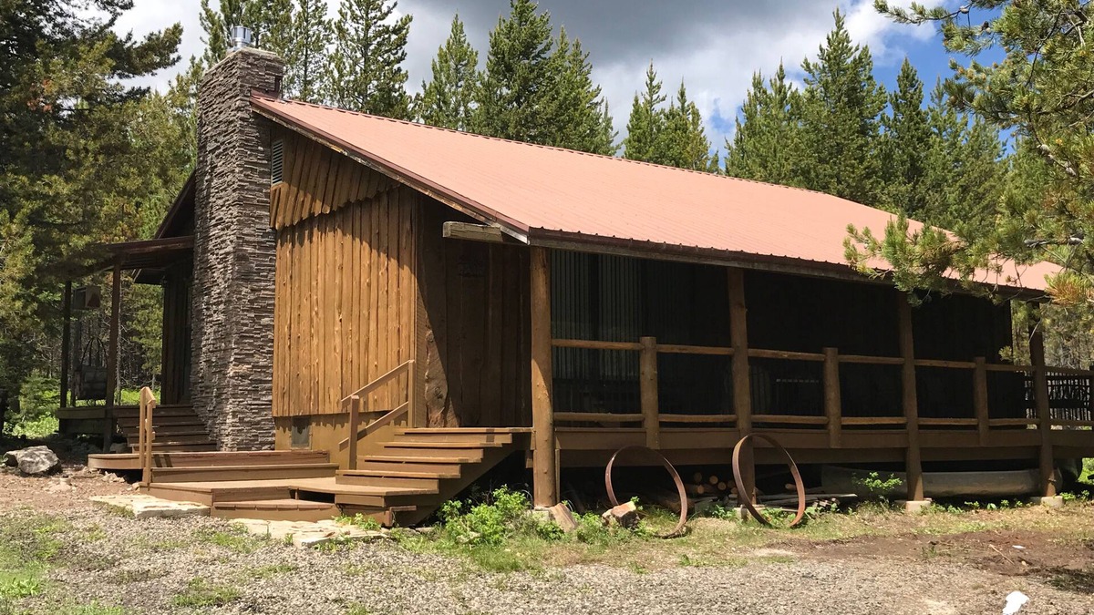 Island Park Cabin | Porch lined cabin nestled in the Pines for lazy summer days