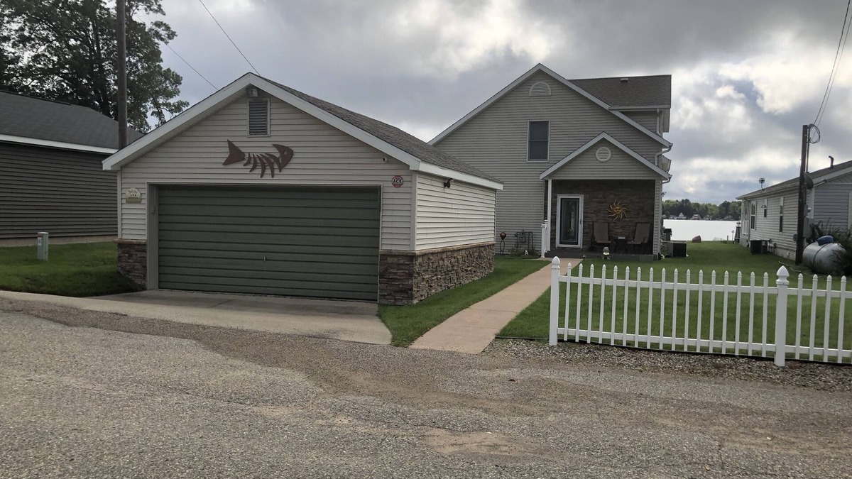 Lake House | Relax at the outdoor firepit or hot tub overlooking all-sports Eight Point Lake!