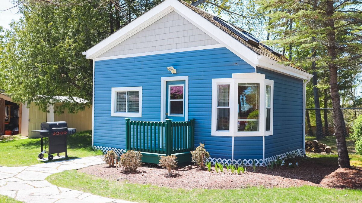 Wasaga Beach Apartment | River View cozy studio cottage with loft, steps shared pool, beach, & firepit