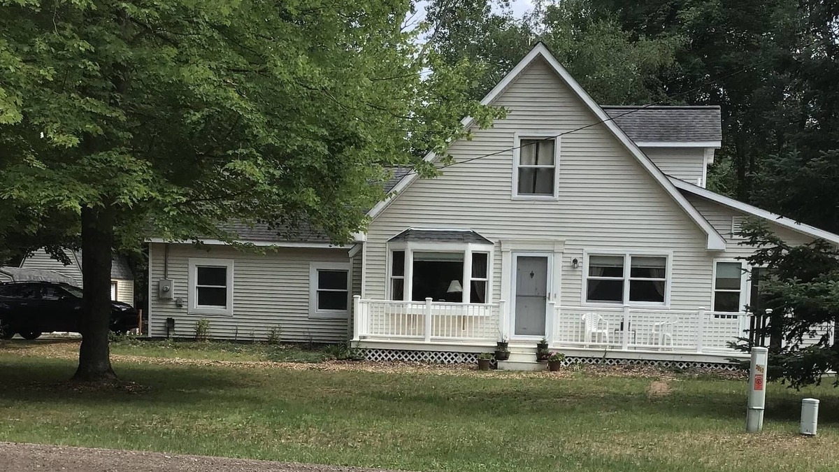 Lake House | Roomy home with spacious fenced in backyard and fire pit.