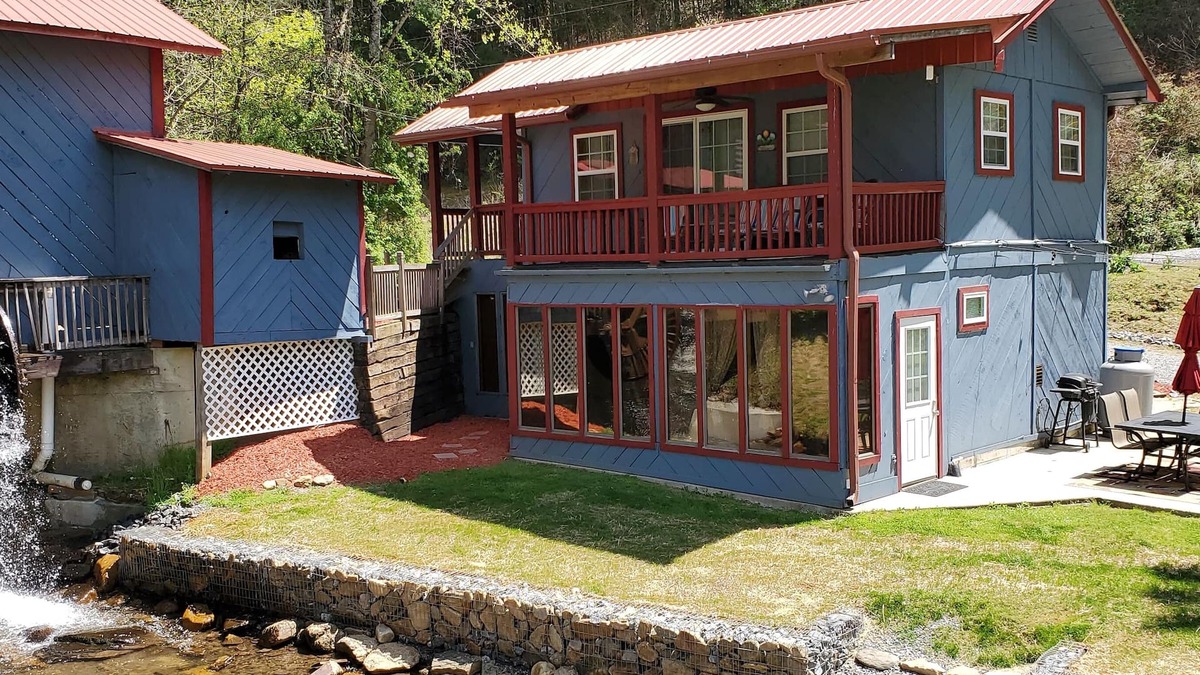 Upper Peachtree Cabin | Rustic two-story cabin on creek with covered bridge and water wheel.