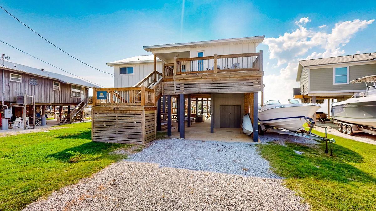 Royal Lagoons House | Serene sound-front home with a covered patio, dock, and swing bed