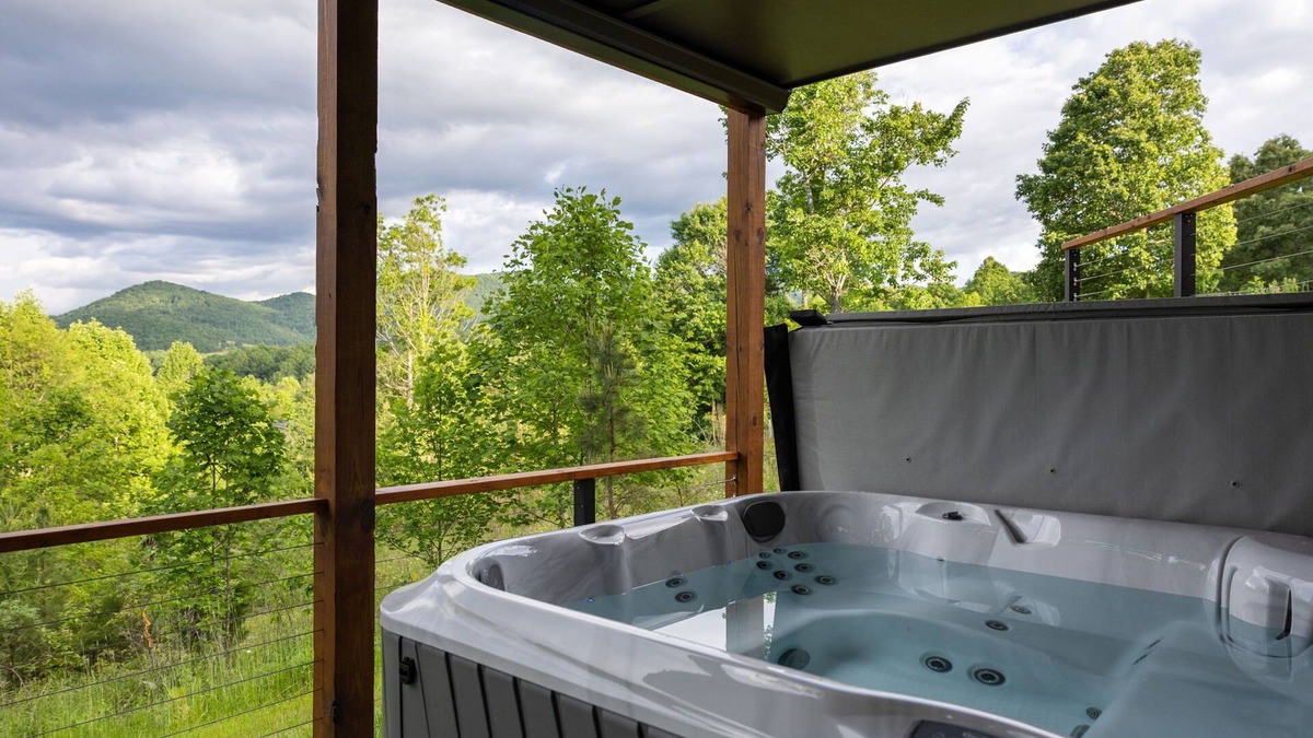Young Harris Cabin | Skip’s Hideaway is a 4BR/3.5BA retreat for 10 in the North Georgia mountains. Enjoy fiery fall views, a private hot tub, gas fireplace, game room, and fenced yard for dogs. Perfect for cozy nights, family fun, and leaf-filled adventures.