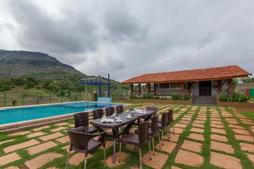 Igatpuri Villa | StayVista's Ficus Farms - Mountain-View Haven with Rustic Artsy Interiors, Outdoor Pool, Glasshouse, Home Theatre & Karaoke Delight