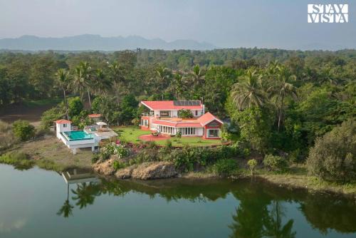 Vada Villa | StayVista's Waterway Retreat - Lakeside Oasis with Infinity Pool