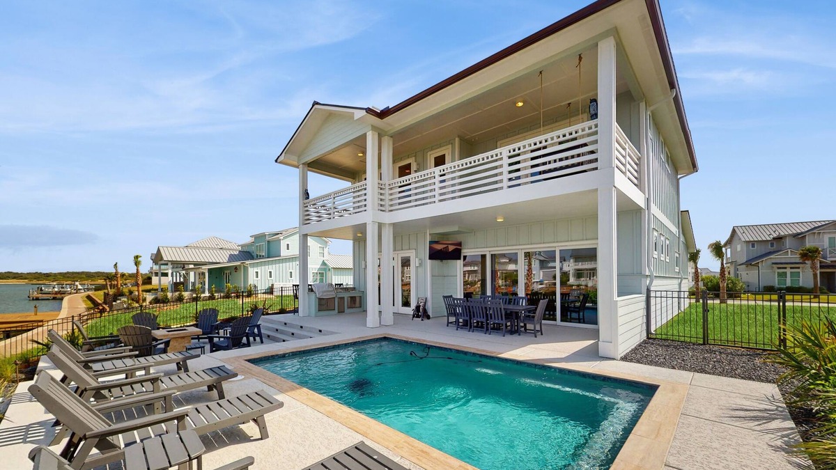 Rockport House | Stunning canal front home with private pool, fire pit, and boat dock