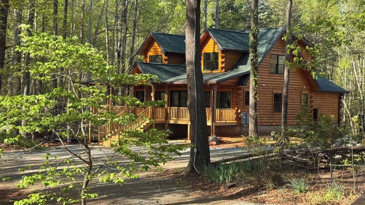 Union Hall Cabin | Stunning SML lakefront cabin: luxurious finishes, spacious rooms, wraparound deck, easy dock access. Family-friendly with toys, media room, serene views!