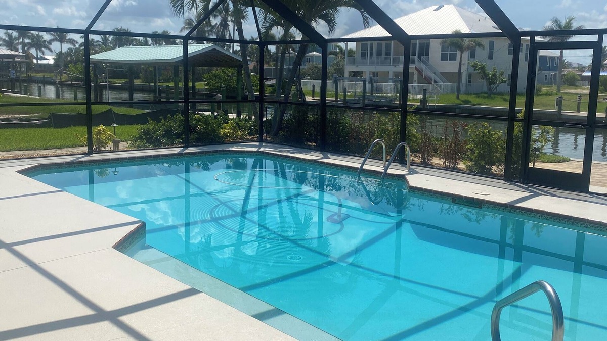 South Island House | Sunny Getaway – Heated Pool, Canal Views, Walk to Beach
