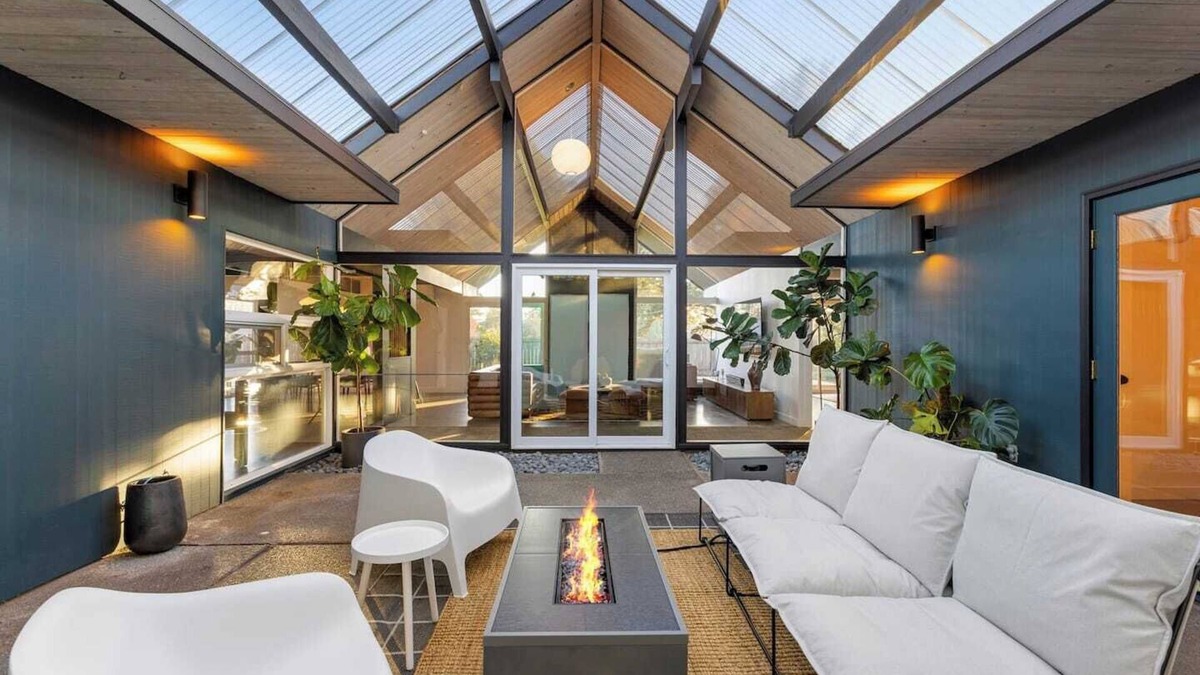 Oak Hills House | This Robert Rummer masterpiece celebrates mid-century design and A. Quincy Jones’ iconic “double gable.” Soak in natural light from the atrium, relax under vaulted ceilings, and retreat to your private hot tub where style and serenity meet.