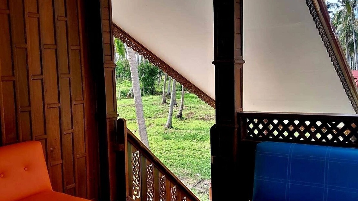 Thong Chai House | Traditional Thai wooden house on stilts set in a coconut orchard near the beach