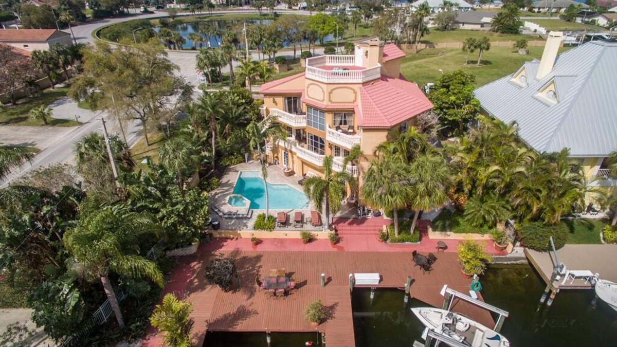 Gulf Harbors House | Tropical Waterfront Resort Home with Marina, Kayaks, Piano, Game Room