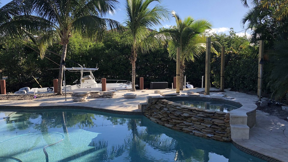 Jupiter House | Tropical waterfront oasis with private dock, pool, waterfall spa, tiki huts.