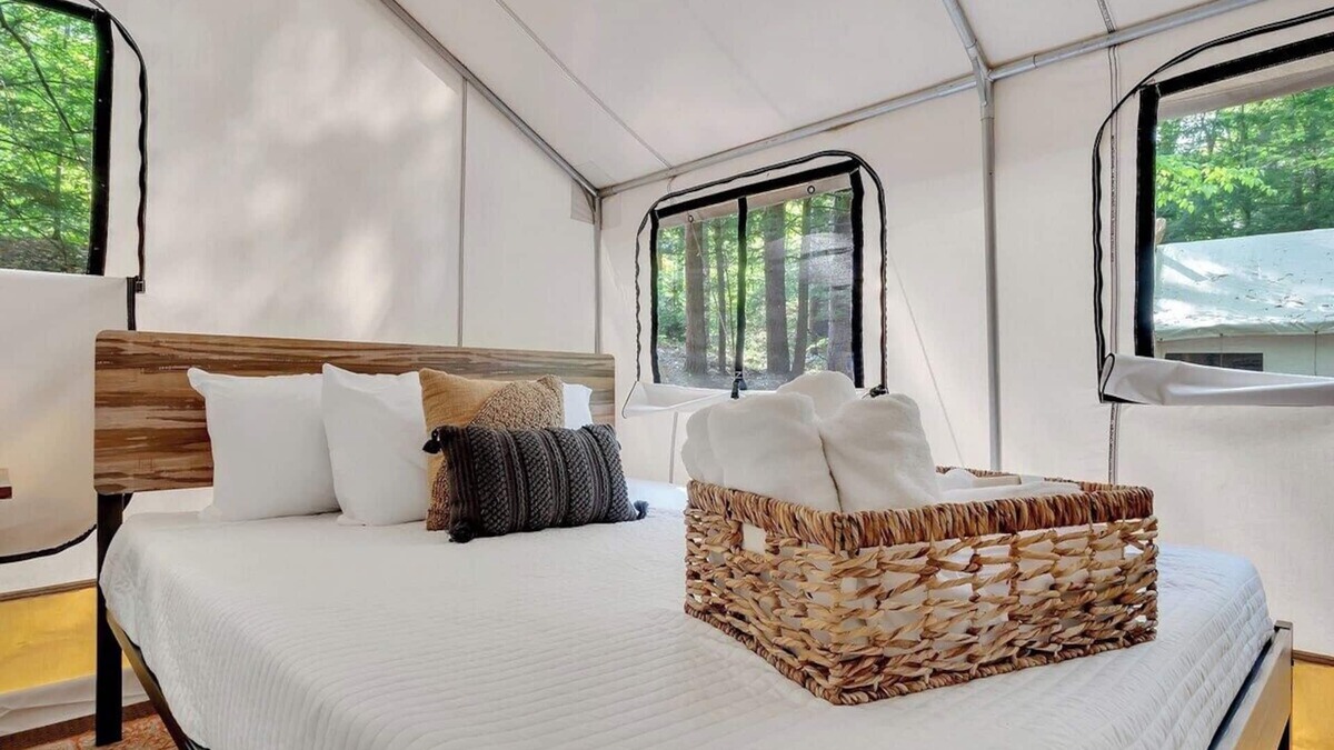 Middle Grove RV Rental | Unplug in comfort—glamping tent with real beds, electricity, fire ring, bathhouse, and nearby pond.