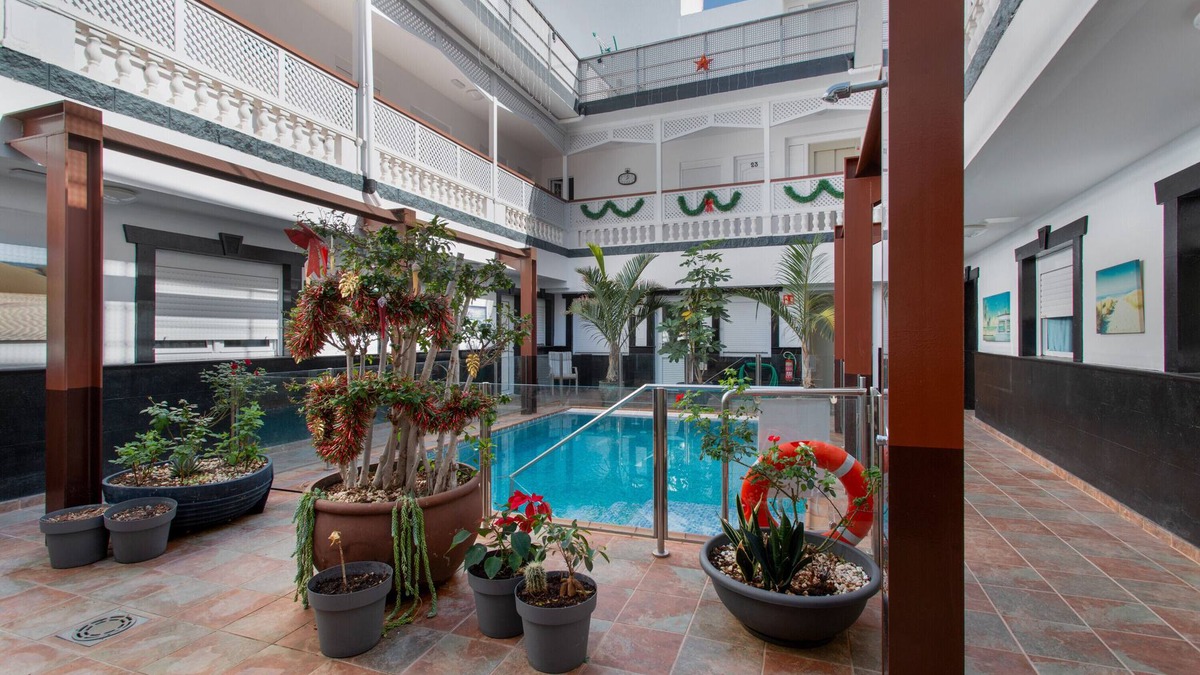 Playa de Arinaga Apartment | Vacation 'Casa Paula - 21' with Mountain View, Shared Pool and Wi-Fi