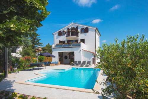 Fazana Villa | Villa Andrija Family Dream with heated pool at the sea with beautiful garden, outside cinema and kids playground