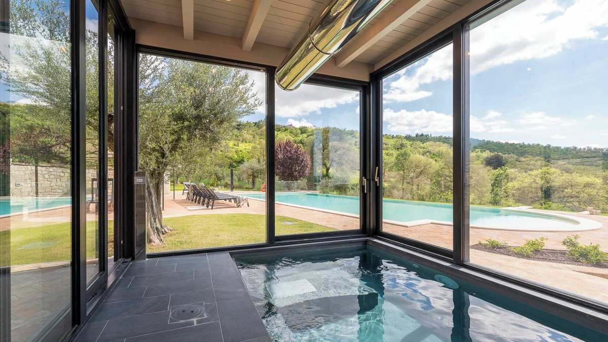 Torricella Villa | Villa Lago is set against a hillside of luscious greenery olive groves