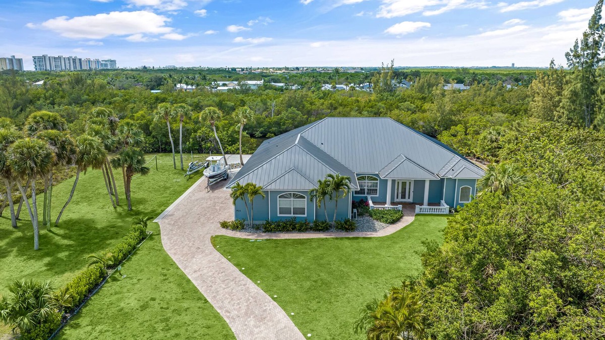 Fort Pierce Shores House | Waterfront home/steps to the beach/private dock/heated pool/spa