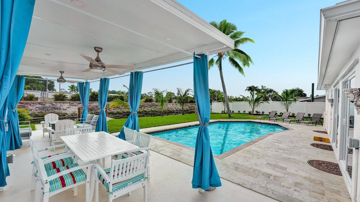 Golfview Harbor House | Waterfront Tropic Oasis: Heated Pool, Pergola, Canal, Dock, Air Hockey!