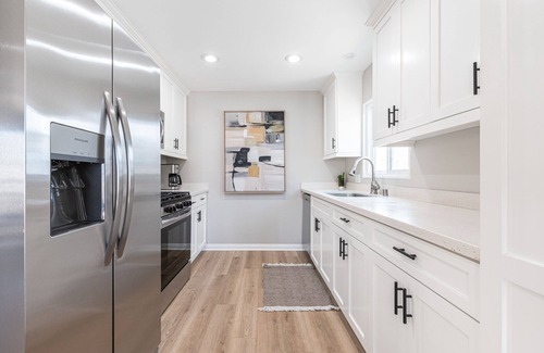 Balboa Peninsula Condo | 6 Total Bedrooms | Modern Interior w/3 Large Patios | Central Location 1 House from the Beach - No Car Needed!