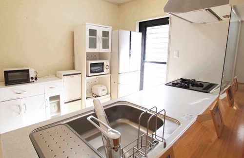 Amami House | A guesthouse limited to one couple. Conveniently located in the center of Amami Oshima for sightseeing. 30 seconds to the largest downtown area, Yajin River. Fully equipped kitchen and laundry facilities are available for long-term stays.