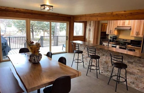 Flagstaff House | Cheerful Cabin with large stone patio and hot tub, next to trails!