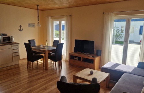 Altefaehr House | Close to the beach holiday home in a quiet field location with a spacious wooden terrace