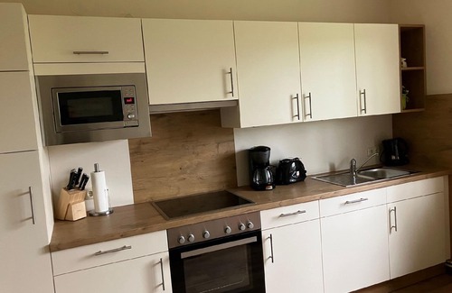 Hobendeich House | Holiday house with a small garden with seating and a grill