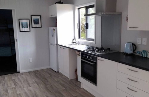 Mangonui House | Itzy Bitzy house is colourful, cosy, fully fenced with sea views