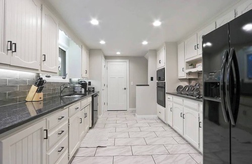 Ashwaubenon House | Lambeau Views + Tailgate Ready! Stay just steps from Lambeau Field with space for up to 12 guests! Enjoy a game-filled garage, hot tub, and backyard views of the stadium. Perfect for Packers games, weddings, family gatherings and group getaways.